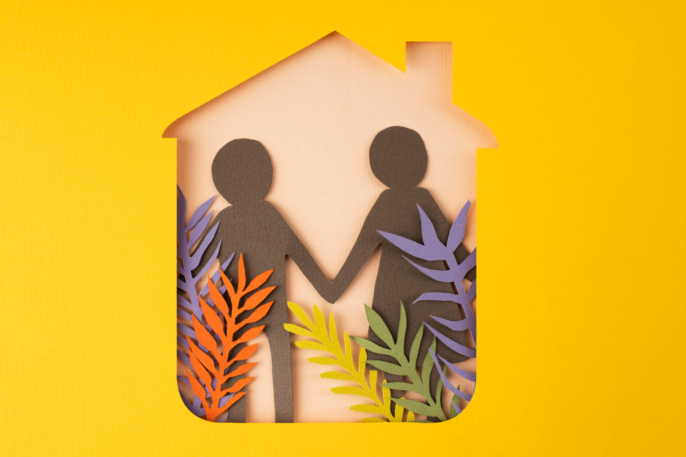 HOA Landscape Maintenance Paper-cut style art of a couple holding hands inside a house shape, symbolizing home and family